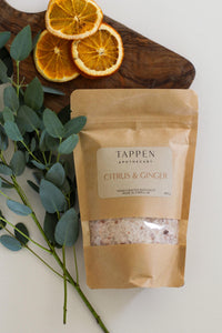 Tappen Apothecary Citrus and Ginger Bath Salts on a wooden board with eucalyptus and dried oranges